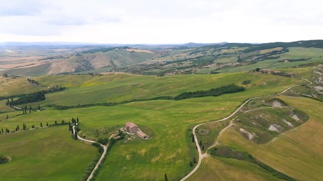 Famous cypress road in Monticchiello, Tuscany. Aerial view from drone in spring season