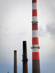 Abstract geometry and shapes of an industrial chimney in red, white, and brown along the I‑95 interstate highway in Bridgeport, Connecticut
