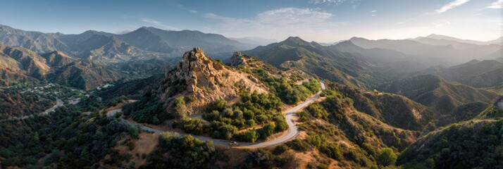 Scenic Landscape of Rolling Hills and Mountains Under a Clear Sky in a Peaceful Valley During Golden Hour