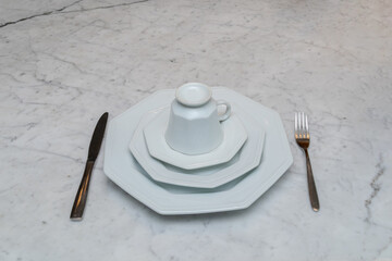 Plates, cups and cutlery on a breakfast table in Rio de Janeiro.