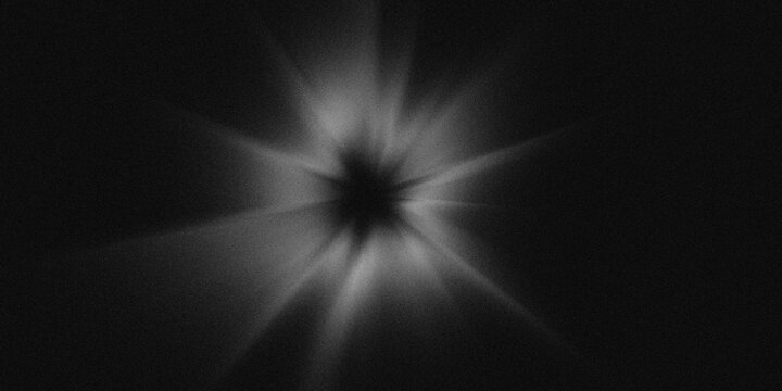 Black and white abstract background with radial bursts of light radiating from a dark central point. Noise texture cinematic film grain design