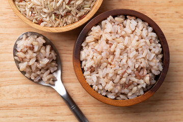 Cooked Thai brown rice in a wooden bowl and spoon, Healthy eating