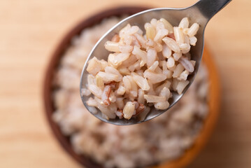 Cooked Thai brown rice in a spoon and bowl, Healthy eating, Top view