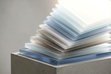 Stack of translucent acrylic sheets in pastel blue and white image photo