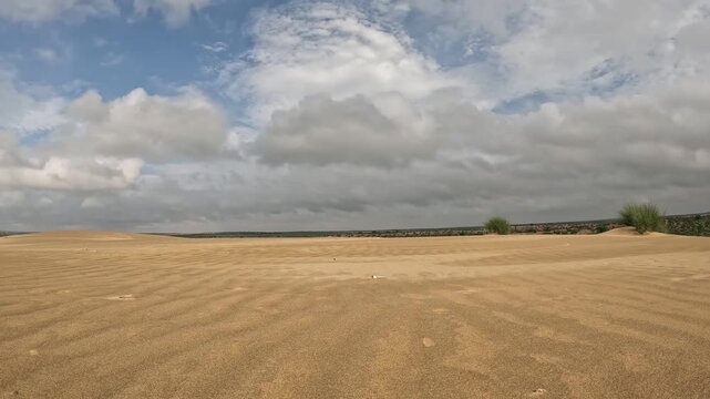 Time lapse of clouds above sand dunes of thar desert