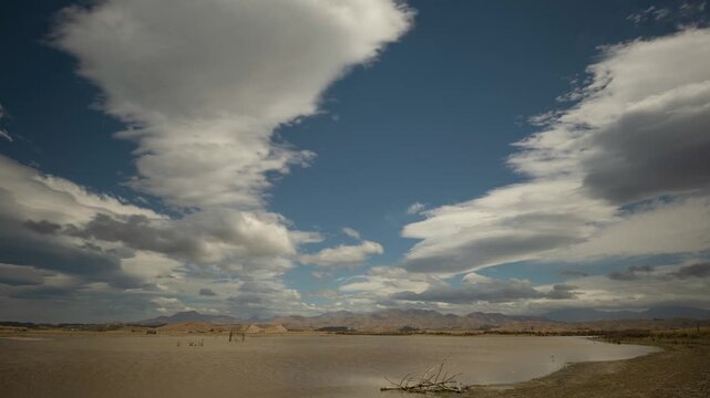 Time lapse of clouds forming and dissipating over the Southern Alps, New Zealand, viewed over Lake Grassmere.
