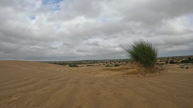 Time lapse of clouds above sand dunes of thar desert