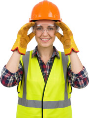 Smiling female construction worker adjusting clear protective safety goggles while wearing an orange hard hat and bright yellow reflective vest over a plaid shirt safety vest
