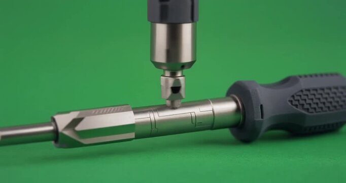Screwdriver on a green screen background with a drill attachment