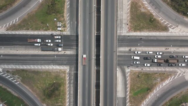 Drone footage scenic landscape of the traffic at bridge over the intersection in the rural place