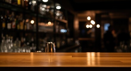 A wooden bar counter in a dimly lit bar with a blurred background of people and bottles.