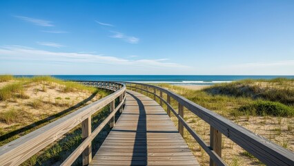 Wooden boardwalk leading to a sandy beach and the ocean under a clear blue sky.