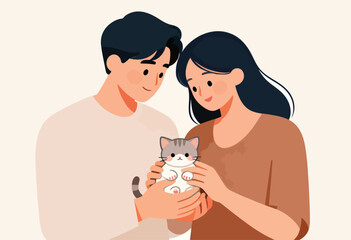 A couple lovingly holds a cute kitten