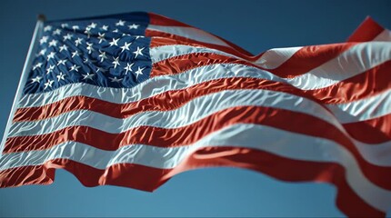 American flag waving against a clear blue sky - Powered by Adobe