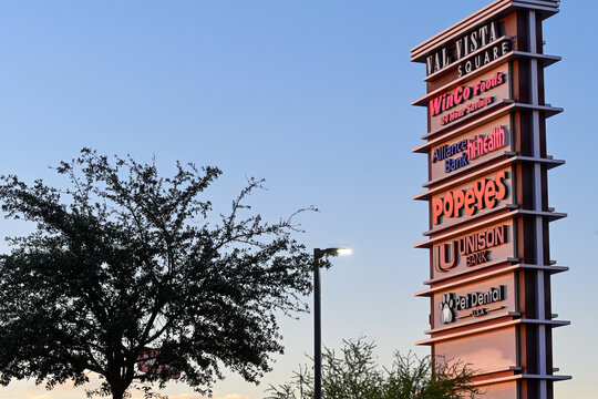 Multi-tenant retail plaza pylon sign displaying WinCo Foods and Popeyes branding, representing roadside commercial signage for multiple grocery and restaurant retail businesses