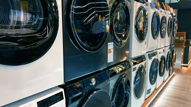 Rows of Modern Front-Load Washing Machines on Display in Appliance Store | New White and Black Laundry Equipment in Retail Showroom | Home Electronics Shopping Concept