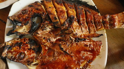 Grilled fish is a traditional Indonesian dish. Some dishes are served with spicy seasonings or...