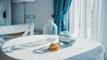 Seashell coastal bedroom linen table glass jar home decor interior nautical seaside beach house morning light sunlight relaxation serenity calm corner furniture. - Powered by Adobe
