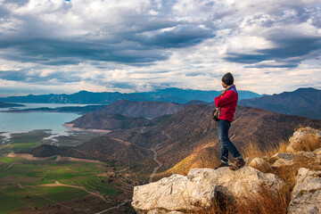 Man Standing on Mountain Cliff Overlooking Lesser Himalayan Landscape, Pakistan