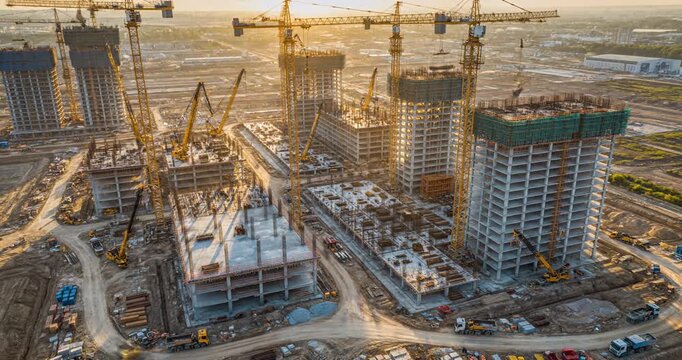 Aerial view of a large construction site with cranes and buildings under development