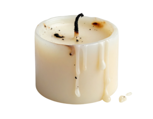 An extinguished, off-white pillar candle with a charred wick and melted wax drips solidified on its side.