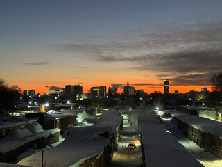 The silhouette of the city at sunset. The shadows of the houses, the warm light of the sun over the horizon. Novosibirsk 2025