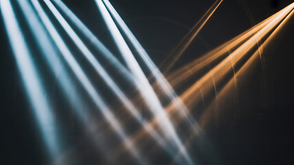 Bright stage lights cast vibrant blue and warm orange beams across a dark, hazy event space