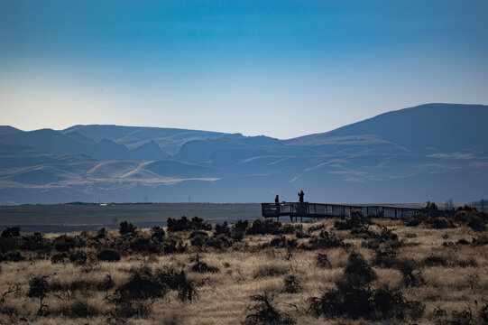 Hikers take in the view of the desert mountain range Owyhees.