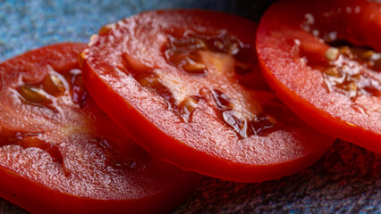Close-up of sliced fresh red tomato with seeds and pulp