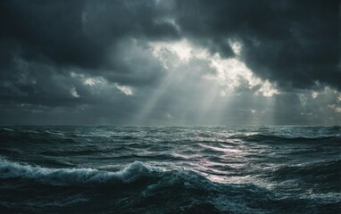 Dramatic seascape with dark clouds and sunlight piercing the sky