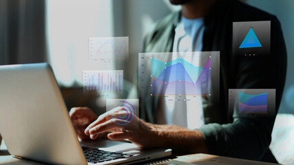 Big data analytics concept with businessman working on laptop, analyzing financial charts, highlighting business development, growth, and strategic planning.