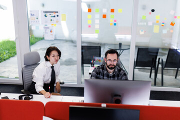 Business meeting between two professionals discussing project strategies in a modern office environment during daytime