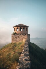Stone tower overlooking foggy valley