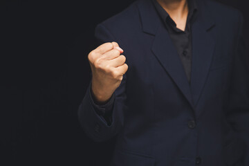 Businessman fist gesture showing power and determination.