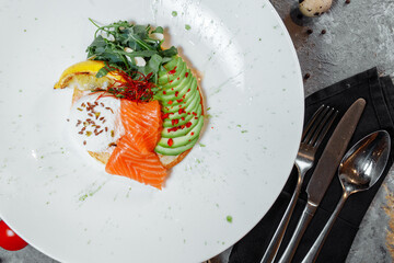 Summer healthy fastfood lunch, breakfast with Pancake with red fish, avocado and egg for breakfast. Aesthetic still life, healthy food concept