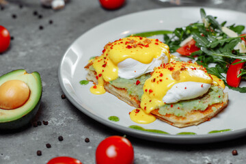 Sandwiches with avocado and poached egg, healthy breakfast.