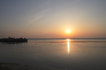 Naklejka premium Sunrise Over the Sea in Wakkanai with a Path of Light on the Water