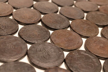 A collection of old, dark Russian Empire 5 kopecks of Catherine II coins arranged in a grid pattern, showcasing intricate designs and details on their surfaces