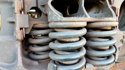Close-up of metal springs and machinery components, showcasing rust and wear