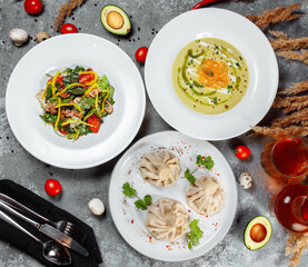 Business lunch set made of three meals. Large lunch set of three courses soup, second course and salad. Caesar salad, Ukrainian borscht and hash brown with mushrooms in a creamy sauce.