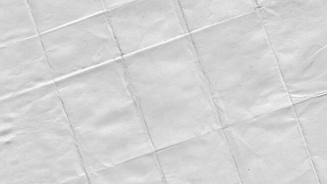 Close up view of a crumpled white paper with folds and texture for abstract backgrounds