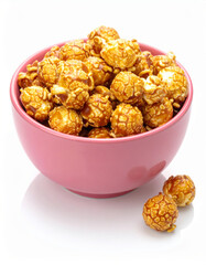 Caramel popcorn filled in pink bowl, on white background