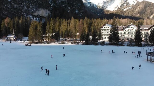 Braies Lake blotted in winter, aerial view from drone, Italian Alps