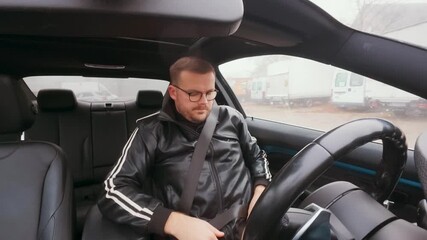 Man in a car fastens his seat belt, checks the belt fit, looks over his shoulder for the blind spot and then drives off, turning safely. Concept for road safety, responsible driving