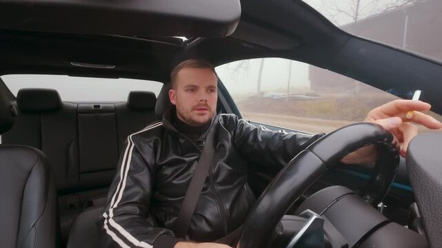 Depressed-looking man drives a car while smoking a cigarette, appearing lost in thought. Concept for stress, loneliness, unhealthy coping, and distracted driving risk.