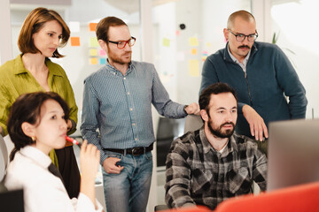 Business team collaborates on project in modern office space during daytime meeting