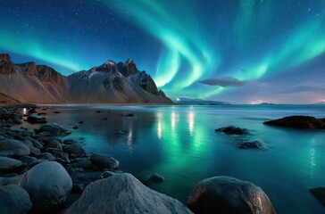 Naklejka premium vestrahorn mountain, black rocks, dark green sky with northern lights