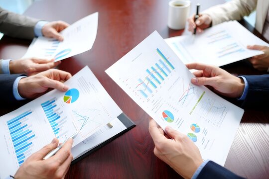 Business Team Reviewing Financial Charts and Data Analysis - Powered by Adobe