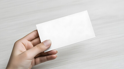 Obraz premium Closeup of a hand holding a blank business card.