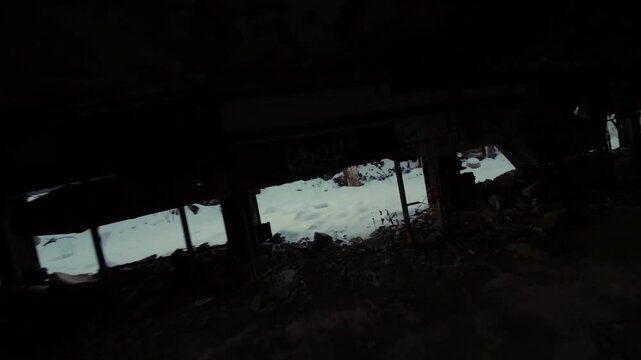 Belgo Factory Shawinigan Quebec Canada FPV drone flying along snow covered bridge with graffiti, abandoned industrial buildings during winter season.